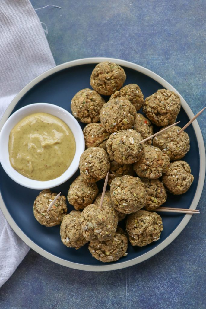Lentil Sausage and Vegan Cheese Balls on a plate