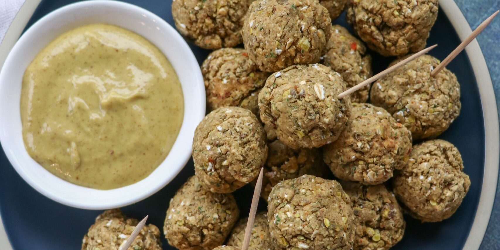 Lentil Sausage and Vegan Cheese Balls on a plate