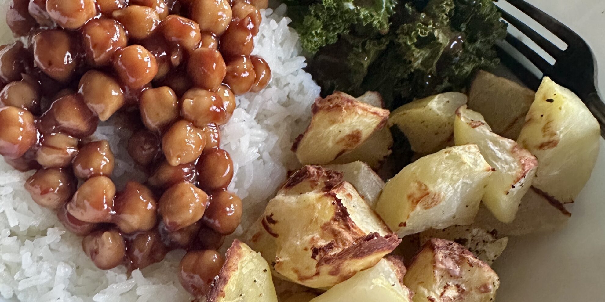 bowl of rice, roasted potatoes, bbq chickpeas and kale